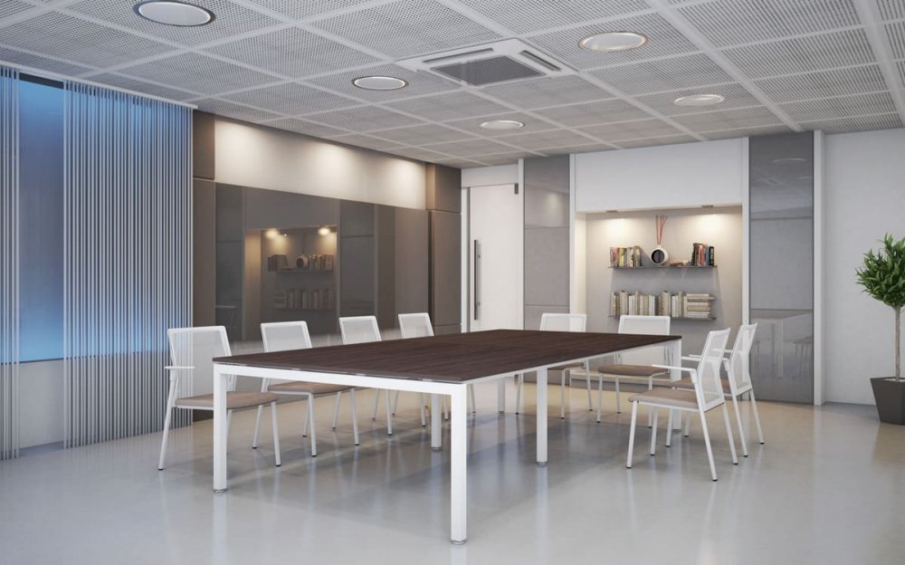 Sala de reuniones moderna con mesa de madera y sillas blancas.